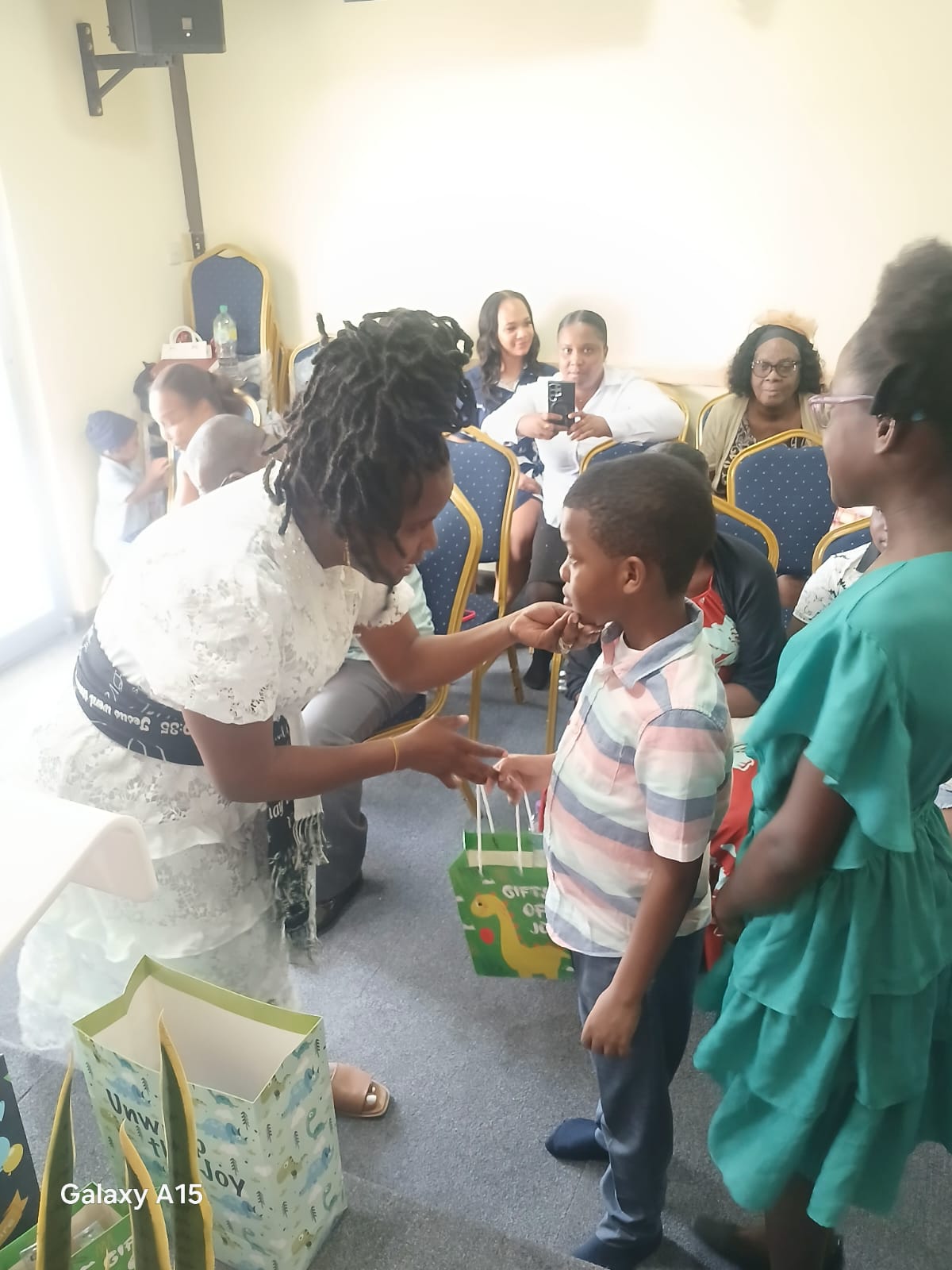 Church leader presenting a gift to a young boy