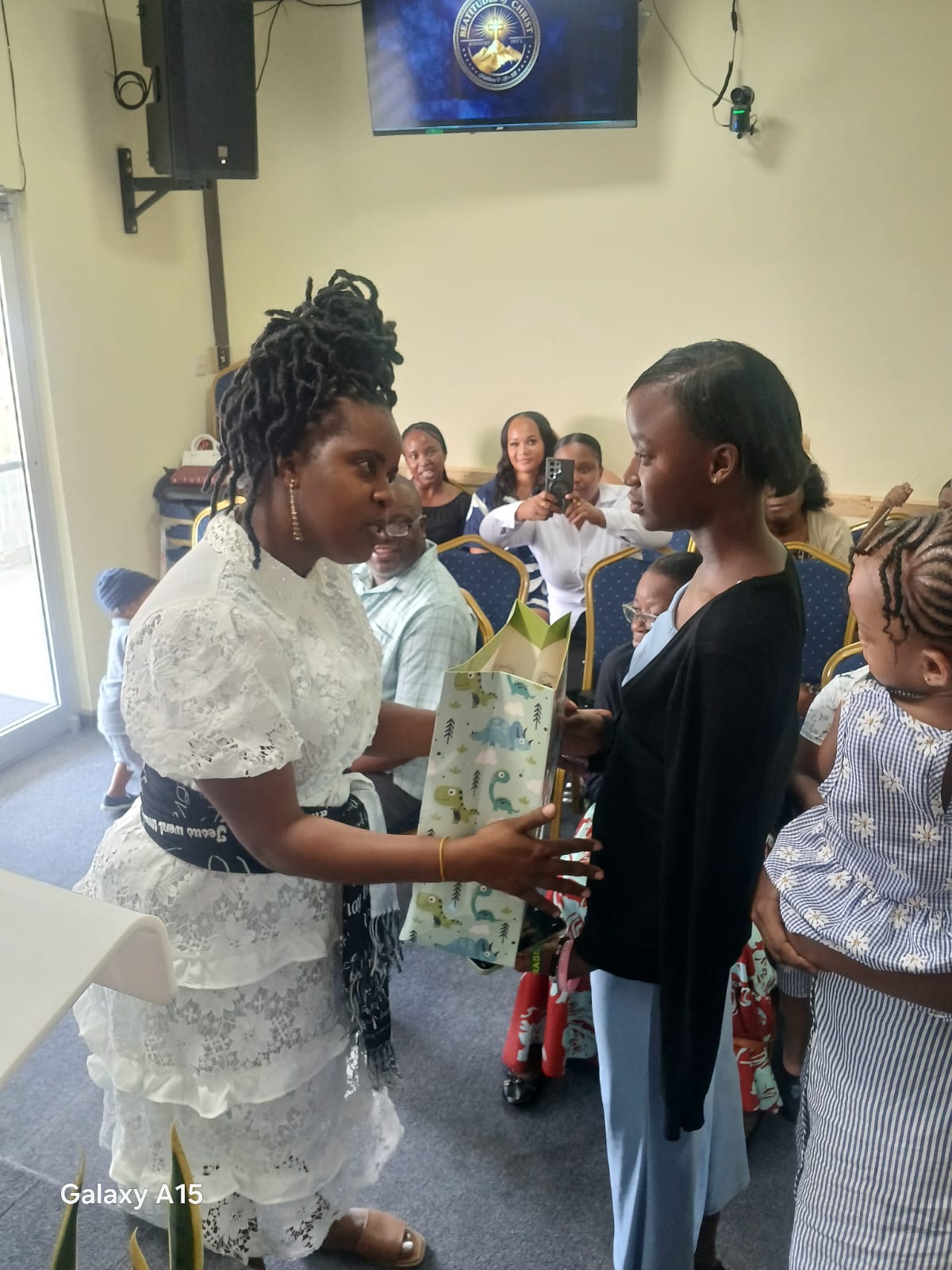 Church leader presenting a gift bag during Back to School 2026