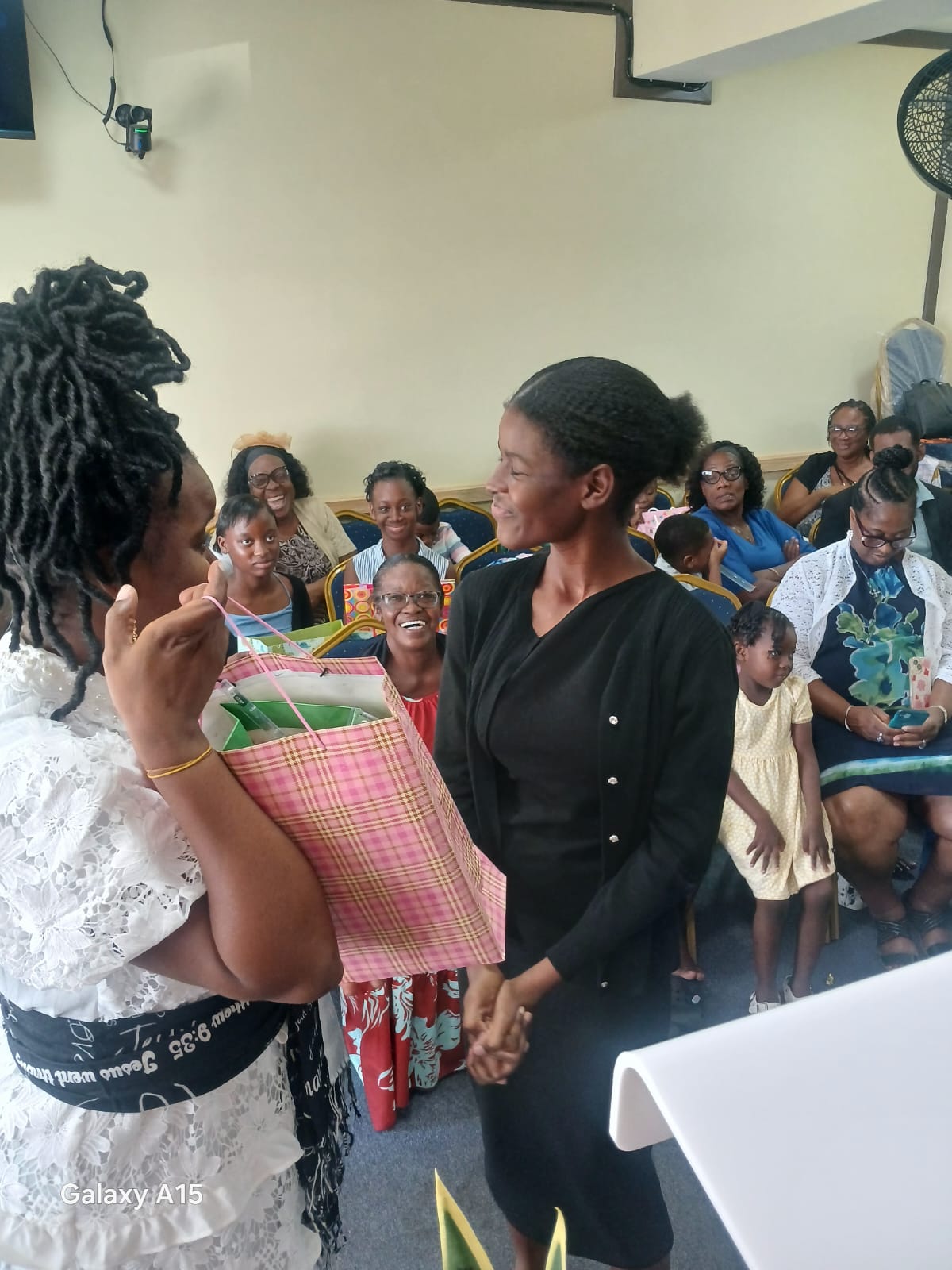 Church member receiving a colorful gift bag